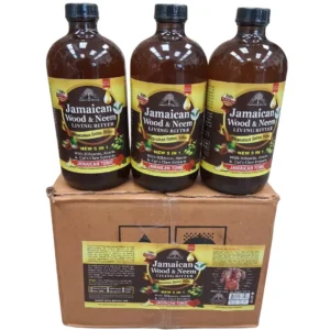 A product shot of three brown glass bottles with black caps and the label "Jamaican Wood & Neem LIVING BITTER Miraculous Detox Bitter 5 IN 1 JAMAICAN TONIC," sitting on top of an unbranded brown corrugated cardboard box. The box has a large label below the bottles with detailed ingredients, instructions, and an illustration of the digestive system. The background is a clean white.