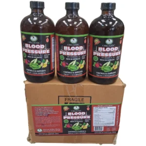 A photograph of three 16oz amber glass bottles of " Organic Blood Pressure Formula" stacked neatly on top of a single brown corrugated cardboard shipping box. Both the bottles and the front of the box prominently display matching labels featuring the red "A.I.H." logo and illustrations of beets, ginger, and turmeric against a black background.
