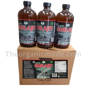 a row of three glass bottles of "Organic SHILAJIT Himalayan Mountain TONIC" on top of their original, branded cardboard display box, set against a white background. The labels clearly show the brand and full ingredient list