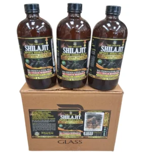 a row of three glass bottles of "Organic SHILAJIT Himalayan Mountain TONIC" on top of their original, branded cardboard display box, set against a white background. The labels clearly show the brand and full ingredient list. Wholesale
