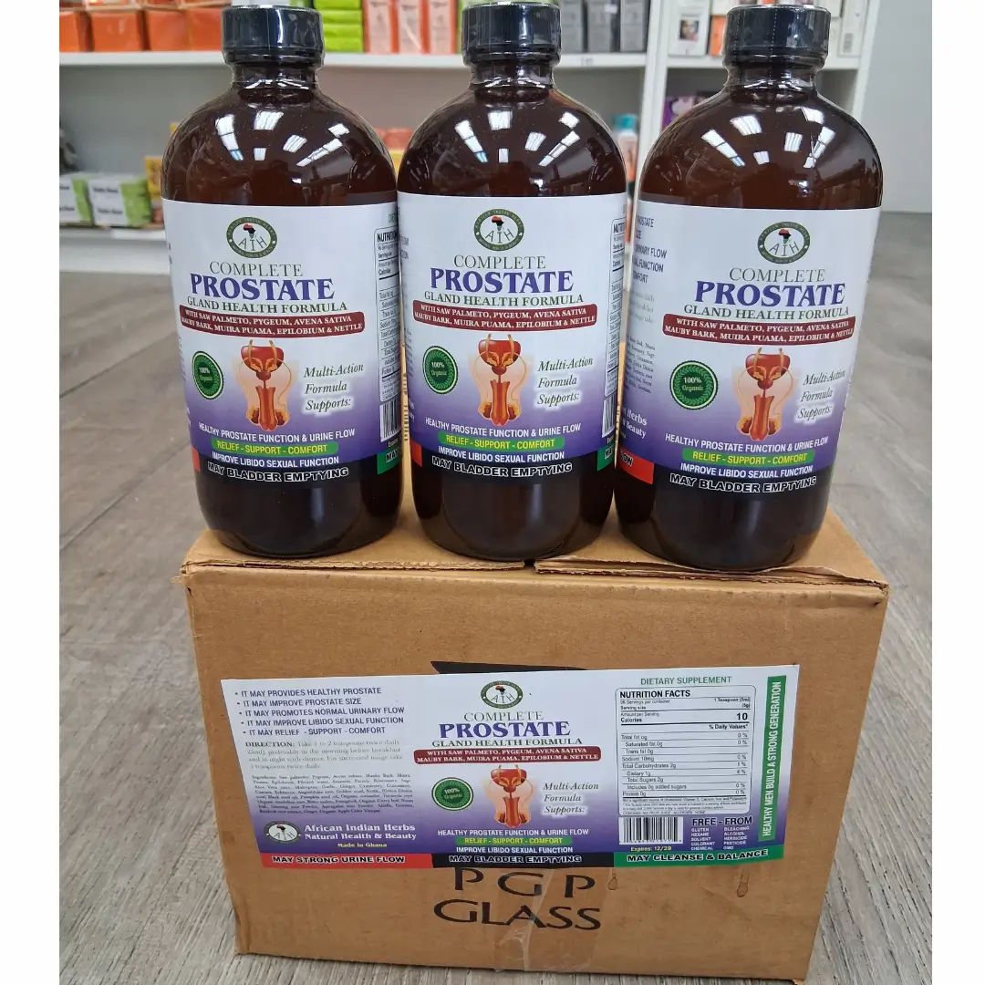 Prostate Gland Health Formula Bitters 16 Oz AIH- (Wholesale) 1 A Clean photograph showing three large, amber glass bottles of "Complete Prostate Gland Health Formula" with black caps, positioned side-by-side on top of a sealed cardboard box. Each bottle features a detailed blue and white label with the product name and key health claims. The cardboard box also has a larger, full label affixed to the front, displaying the supplement facts panel and product description. The image is taken from a three-quarter view, slightly elevated. A large, transparent watermark text "Theorganicmade.com" overlays the lower half of the image. The bottles are filled with a liquid supplement. The packaging looks secure and professional.