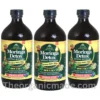A vibrant promotional ad graphic for Essential Palace Organic Moringa Detox Living Bitters. The large 16oz dark amber glass bottle is featured prominently on the left, with a label detailing its ingredients (Lemon Grass, Fenugreek, Garlic, Juniper Berry, Fennel Extracts) and claims ("NEW 5 IN 1 Miraculous Detox Bitter"). To the right, a large white text block under a green "RELIEF FOR:" headline features a bulleted list: "Blood Sugar & Blood Pressure Levels," "Improved Digestion," "Boosts Immune System," "Enhanced Skin Health," "Energy Support," "Antioxidant, Anti-inflammatory, & Detoxify," and "Cardiovascular Health." Below the list is the website URL "www.theorganicmade.com" and a "The Organic Made" trust seal. The foreground displays fresh ingredients corresponding to the list, including lemongrass stalks, moringa leaves, and fenugreek seeds. pack of 3