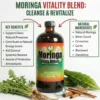 A central glass bottle of Moringa Living Bitters is positioned above a light wood table, flanked by two text boxes. The left box, titled 'KEY BENEFITS', lists bullet points: 'Support Detoxification', 'Boost Energy', 'Anti-inflammatory', and 'Rich in Antioxidants'. The right box, titled 'NATURAL INGREDIENTS', lists: 'Natural Moringa', 'Bitter Gourd', 'Cinnamon', 'Garlic', 'Blackseed', and 'Dandelion'. Red arrows curve inward, pointing to the bottle. Raw ingredients are arranged around the base: a large cluster of fresh dandelion greens and roots, two whole bitter gourd vegetables, and cinnamon sticks. The top green banner reads 'REVITALIZE YOUR WELLNESS', followed by 'MORINGA LIVING BITTERS:' in red, and 'Detox & ENERGY BEVERAGE' in green. A dark footer bar displays 'FUEL YOUR BODY • LIVE VIBRANTLY'.